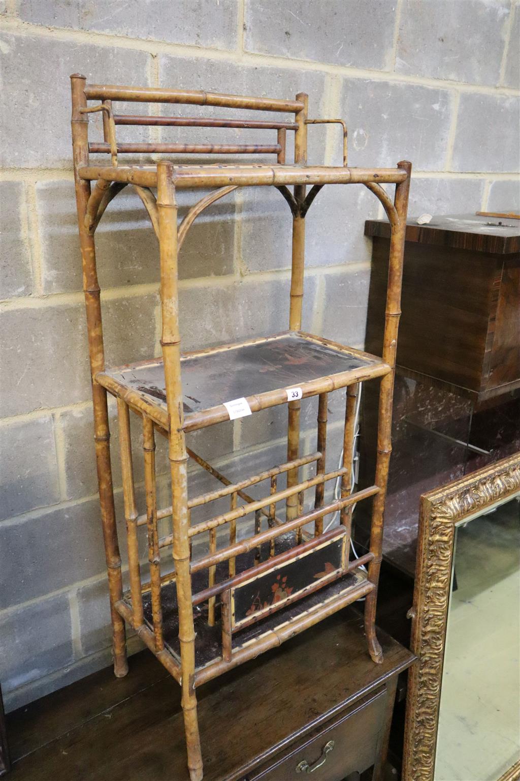 A late Victorian lacquered three tier bamboo Canterbury whatnot, width 50cm, depth 31cm, height 120cm